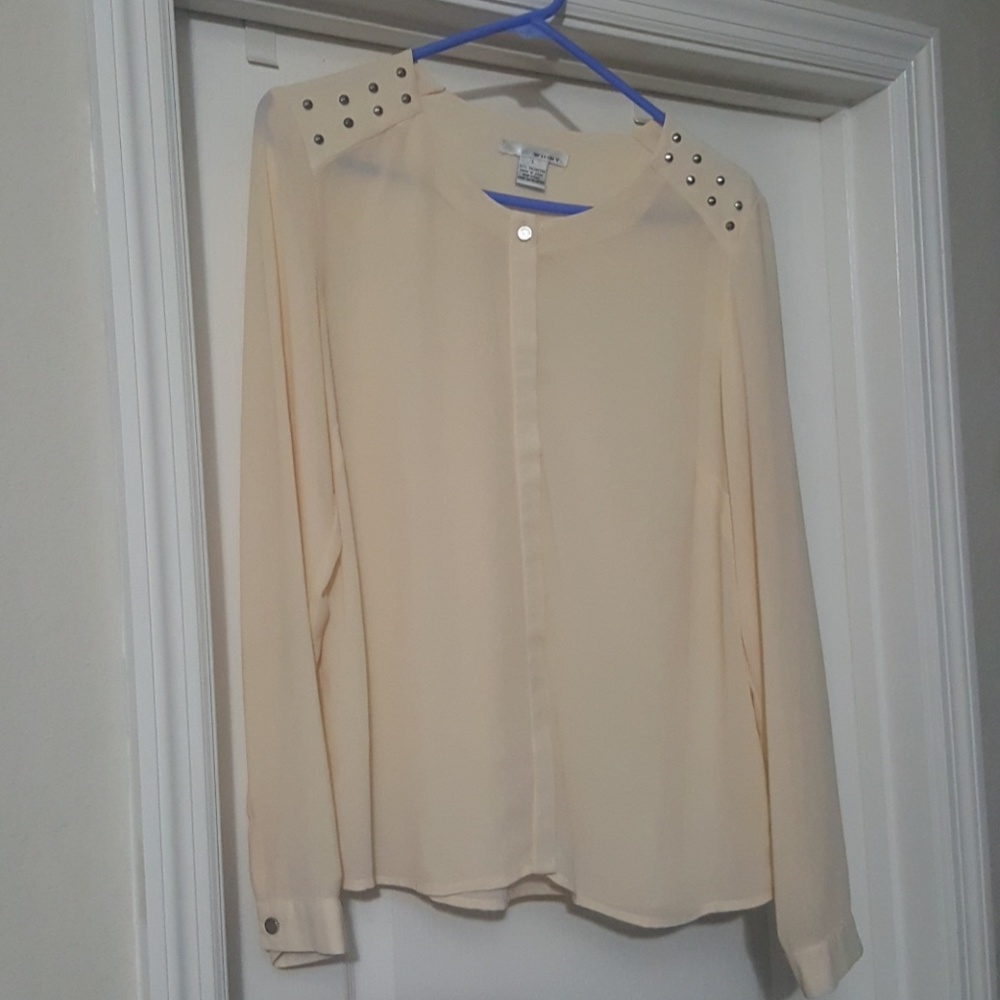 Cream blouse with silver studded detail.